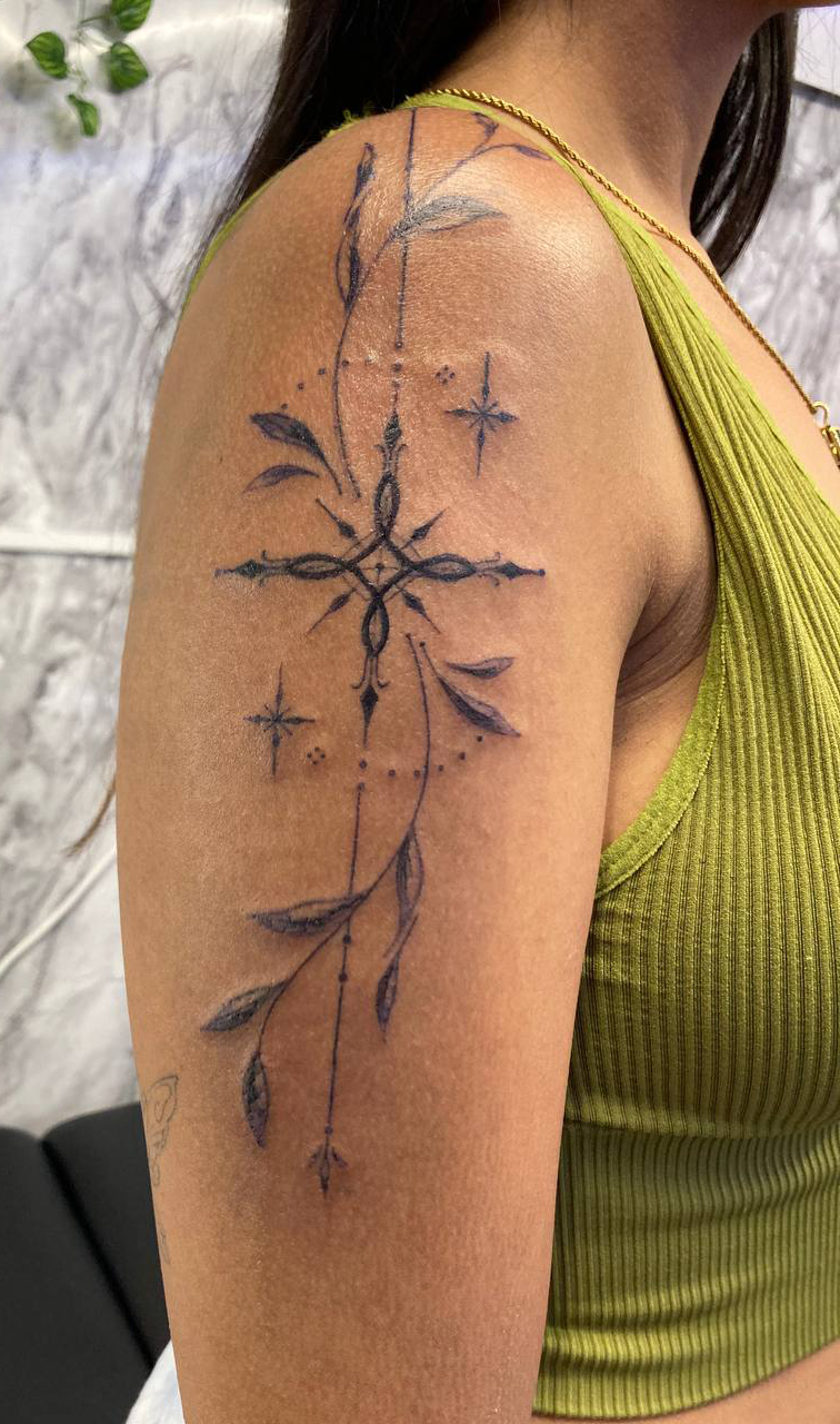 Fine line ornamental cross tattoo